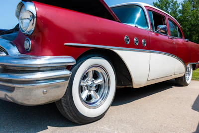 A classic antique car parked outside the Ironbucket shop under a bright Montana sky.