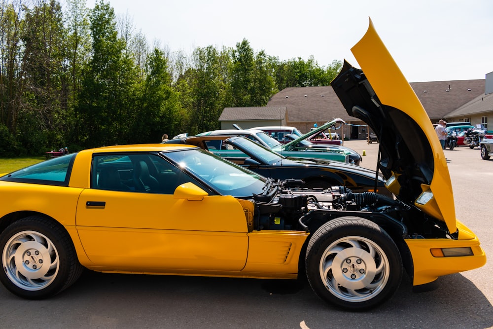 a yellow sports car with its hood open