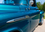 Before-and-after side-by-side of a truck’s exterior transformation with restored trim.