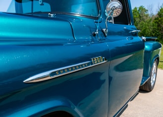A close-up of the truck's cherry red paint shining in the sun.