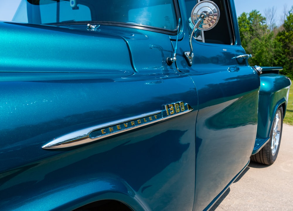 a close up of the front end of a blue truck