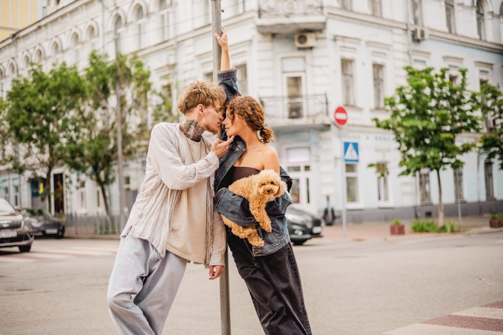 a man and a woman standing next to a street sign