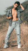 Man walking outdoors wearing trendy light-wash denim jeans with a relaxed fit.