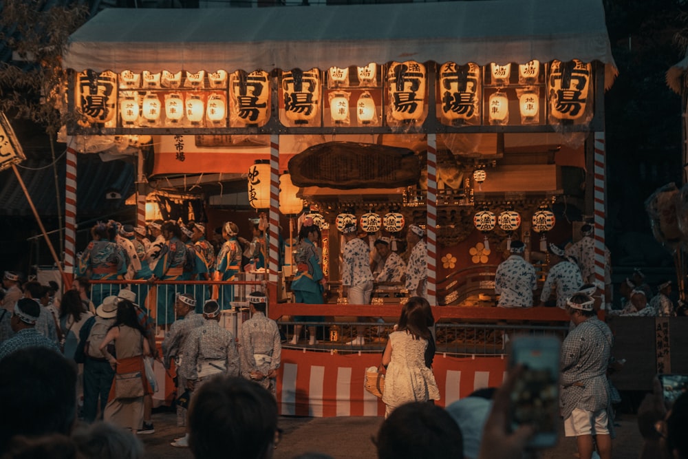 a group of people standing around a carnival