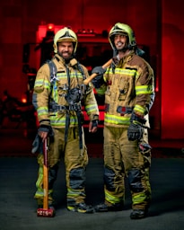 a couple of fire fighters standing next to each other