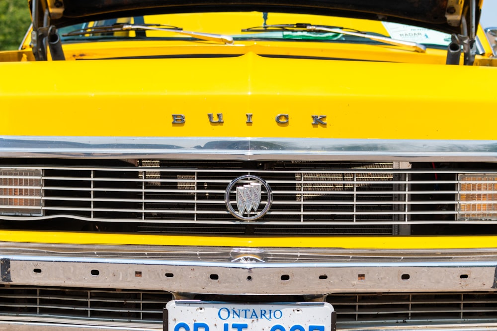 a close up of a yellow truck with a license plate