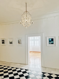 A bright living room illuminated by beautiful chandeliers.