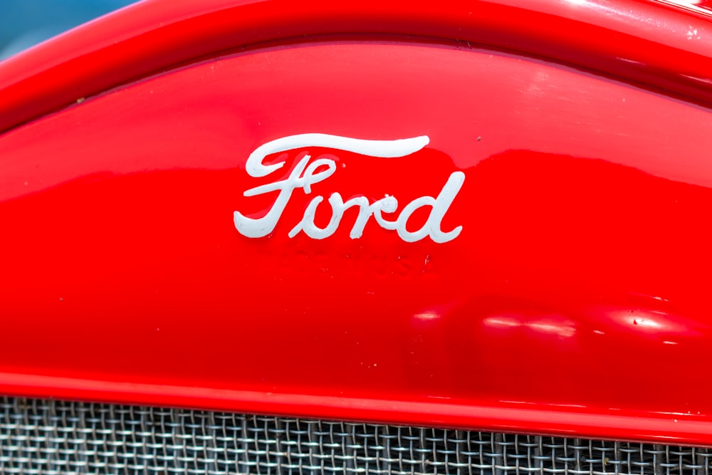 a close up of the emblem on a red car