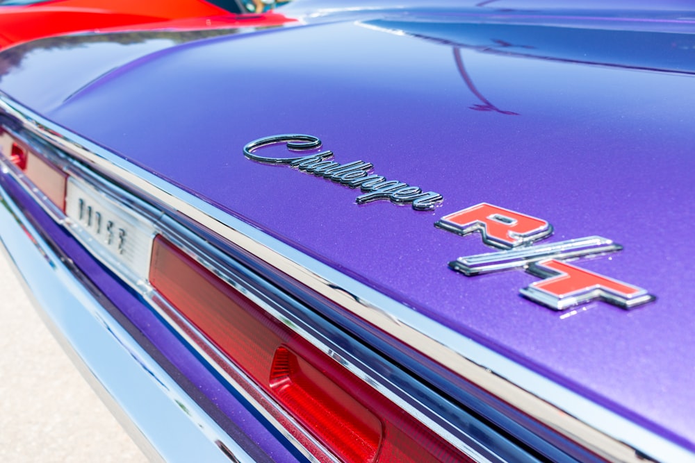 a close up of the emblem on a purple car