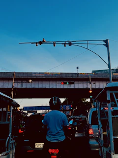 Rider crossing a busy intersection in Dubai, with high-rise buildings and glowing traffic lights.