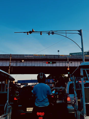 Rider crossing a busy intersection in Dubai, with high-rise buildings and glowing traffic lights.