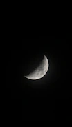 Astronauts exploring the moon’s surface under a deep black sky.