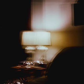 Lifestyle shot capturing the calming glow of smart comfort devices in a modern, minimalist living room with dark tones and subtle blur effects.