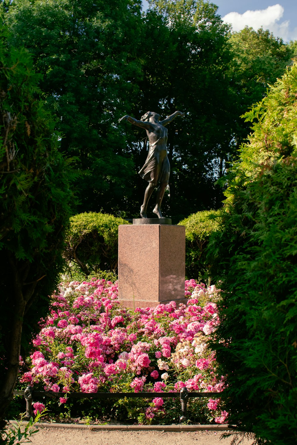 a statue of a woman surrounded by flowers