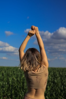 A vibrant morning scene showing a person joyfully stretching outdoors, energized and ready to start the 21-day reset challenge.