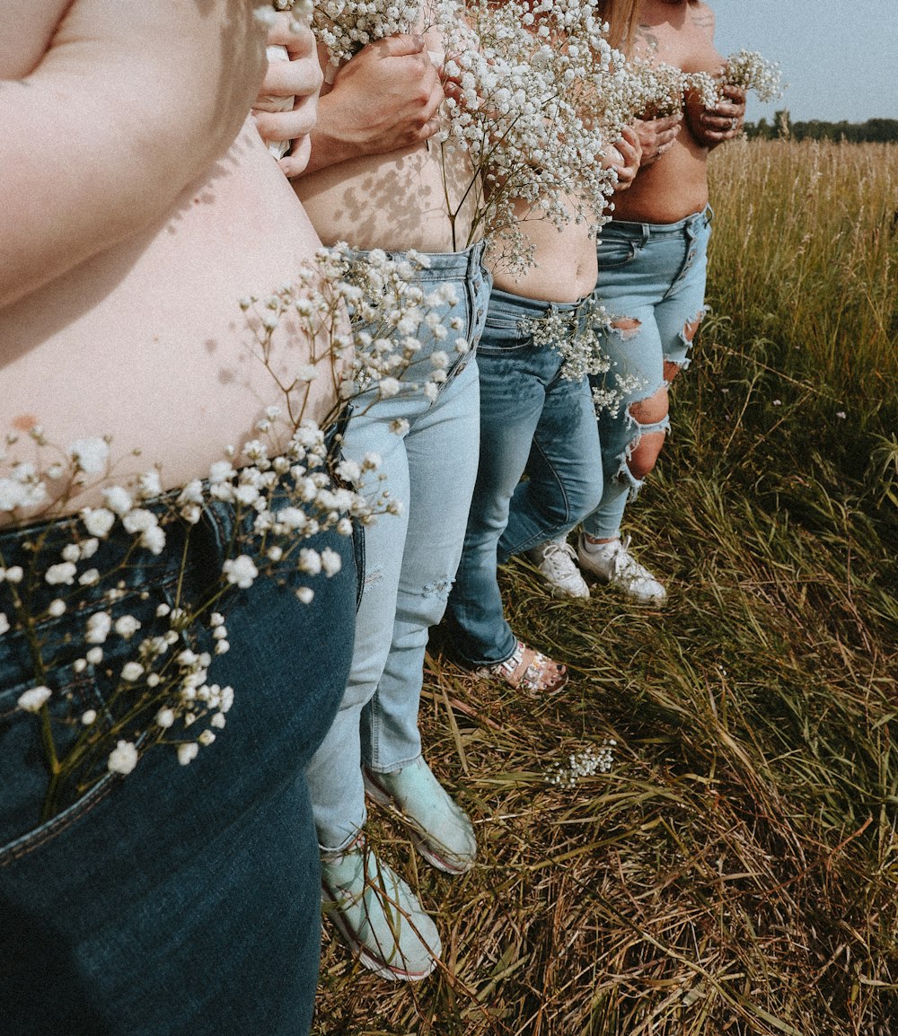 a group of women standing next to each other in a field