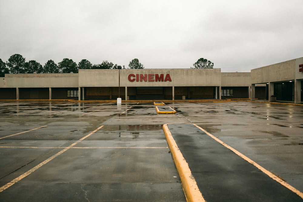 an empty parking lot in front of a movie theater