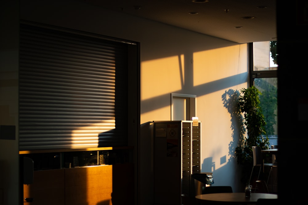 a room with a window, a table and a chair