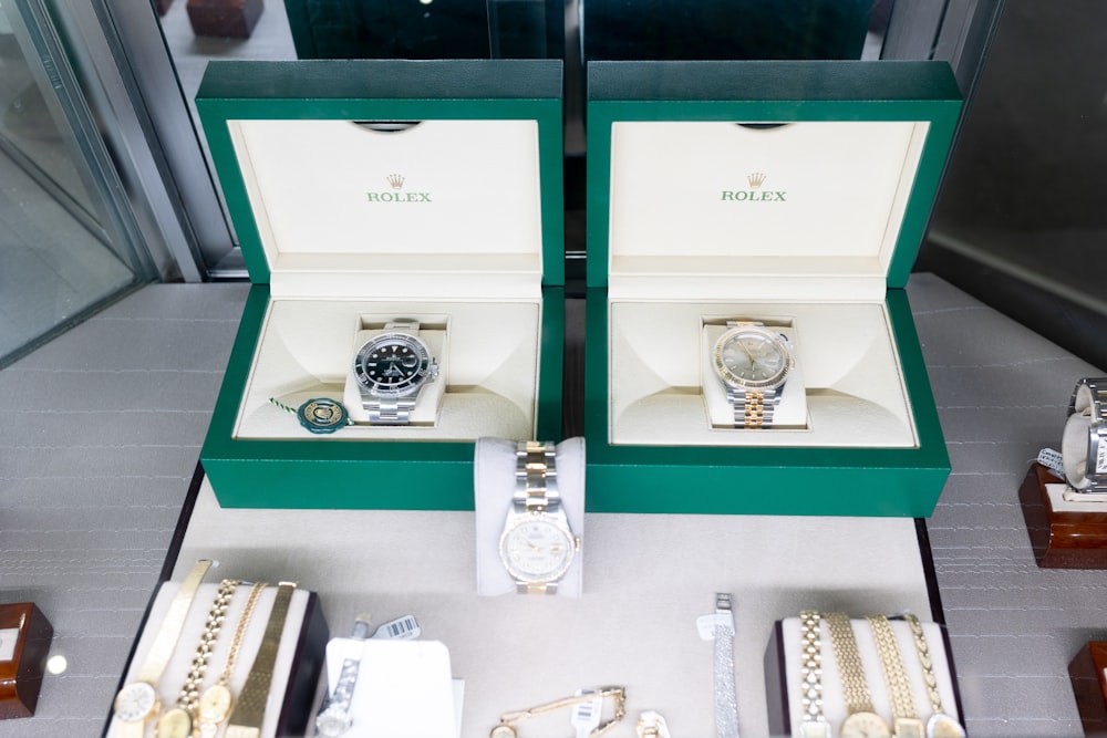 a couple of watches sitting inside of a green box