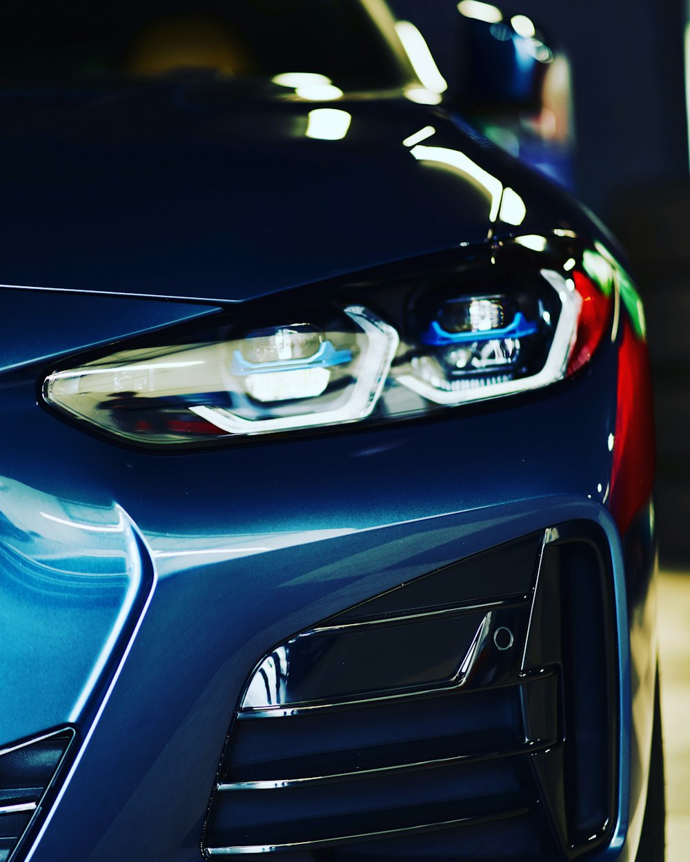 a close up of the front of a blue sports car