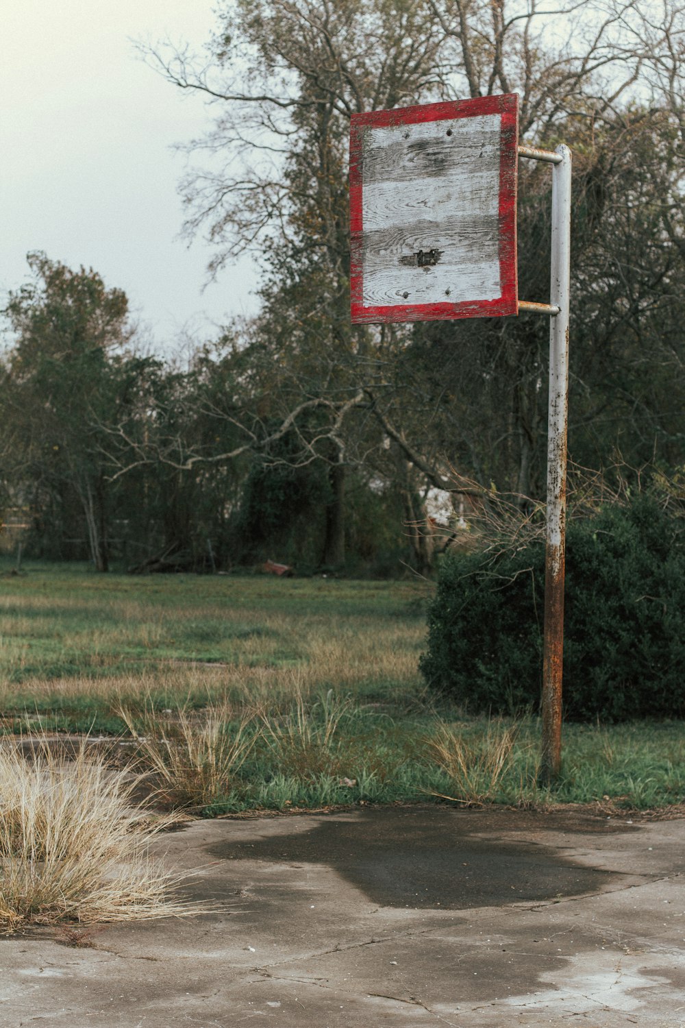 a red and white sign sitting on the side of a road