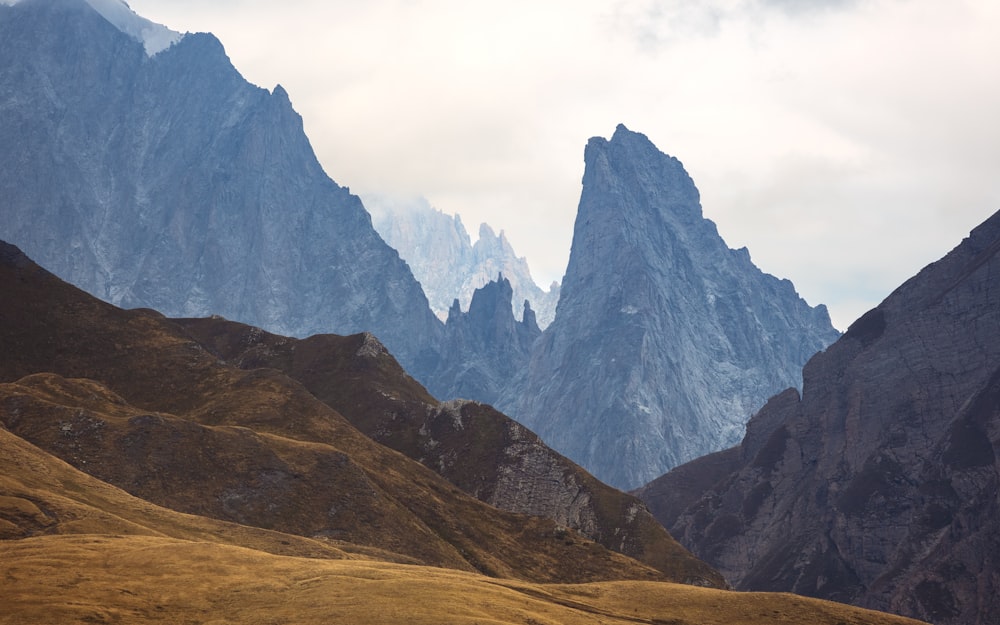 a group of mountains in the distance with a sky background