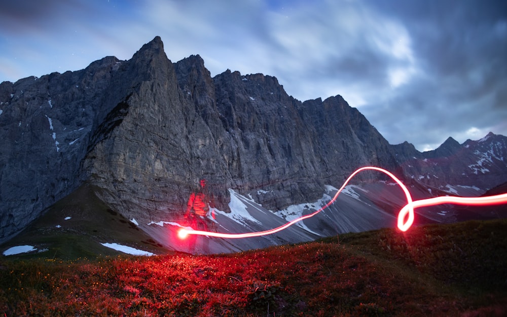 a long exposure photo of a person on a mountain