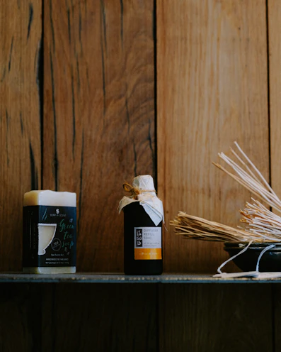 Soothing essential oils and balms displayed on a rustic wooden shelf with soft natural light.