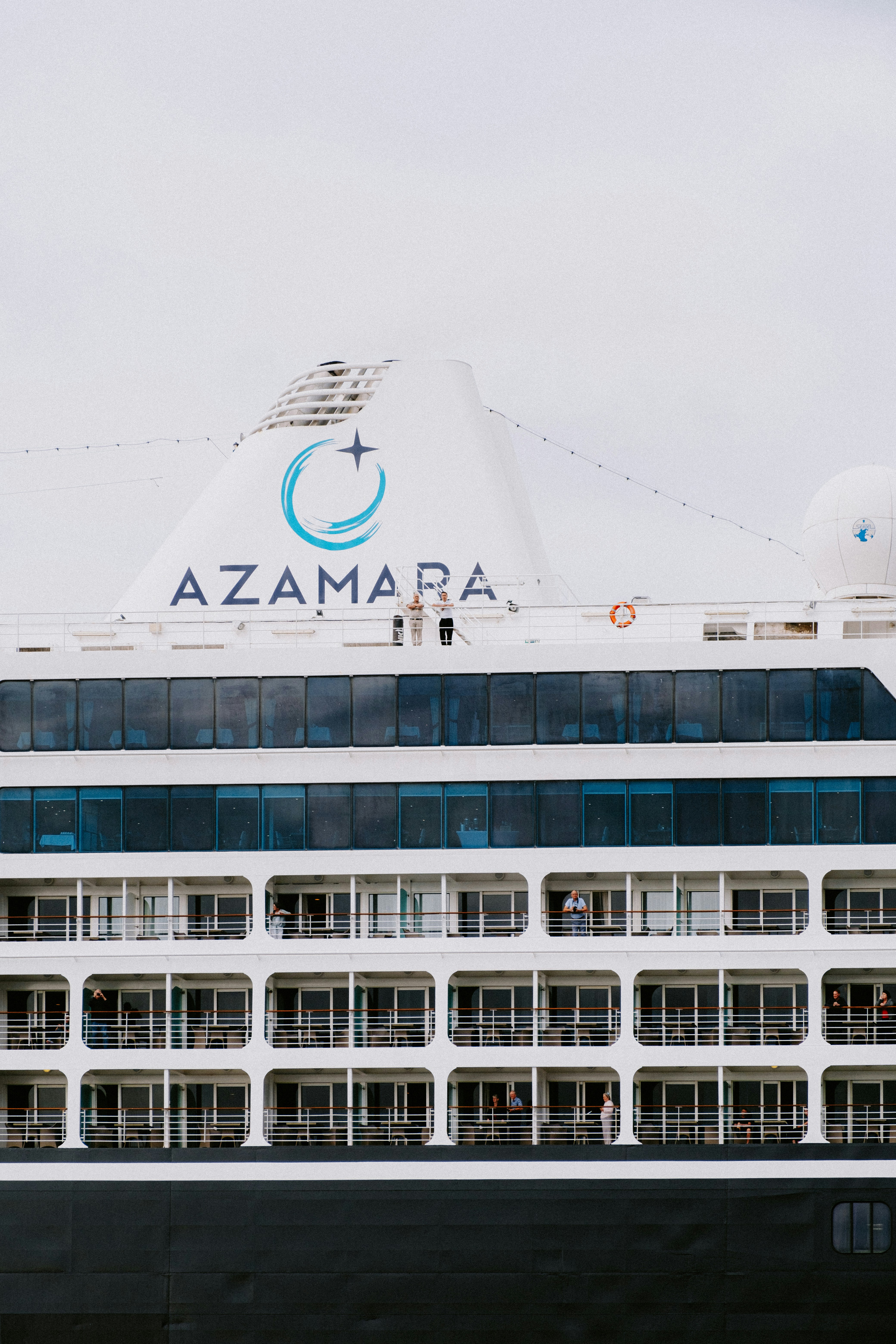 a large cruise ship with a blue and white logo on it's side