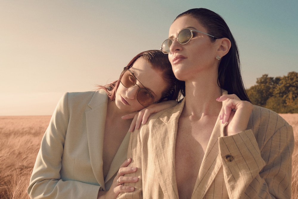 two women standing in a field of tall grass