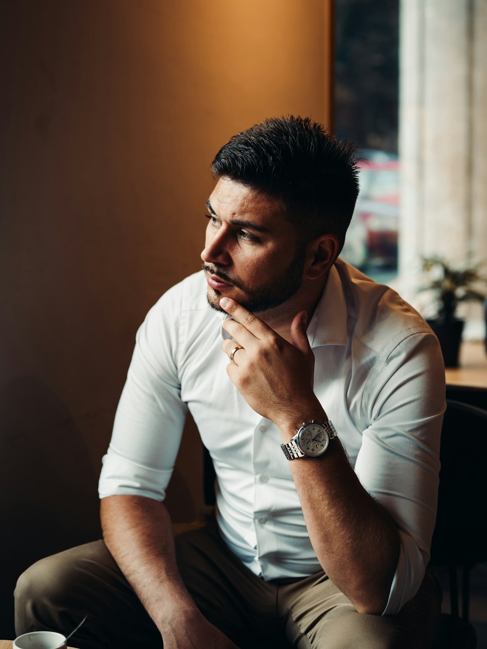 a man in a white shirt and khaki pants