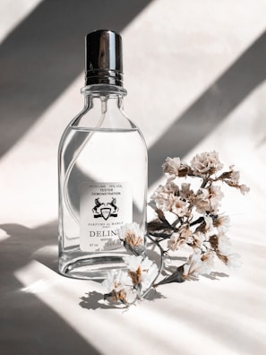 A beautifully arranged perfume bottle surrounded by soft shadows.