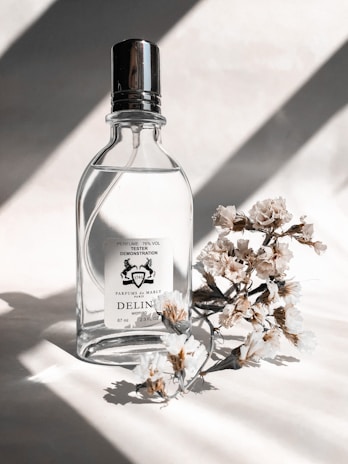 Close-up of a delicate perfume bottle with soft natural lighting highlighting its elegant design.