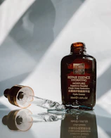 SK-II facial treatment essence bottle with water droplets emphasizing freshness