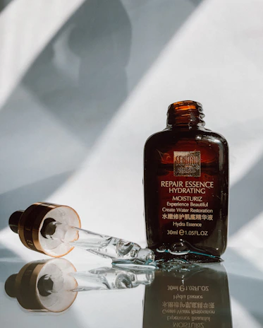 Elegant bottle of hydrating facial serum with a dropper, glowing softly under warm light.
