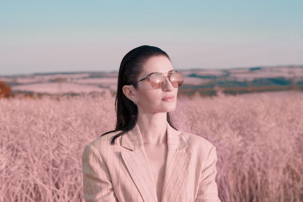 a woman standing in a field of tall grass