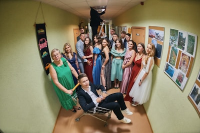 a group of people standing and sitting in a hallway