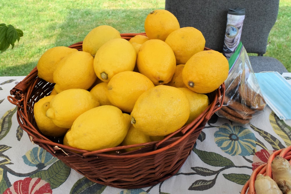 a basket full of lemons sitting on a table