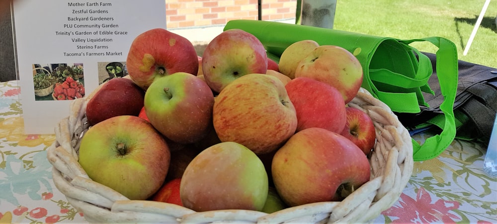 a basket full of apples sitting on a table