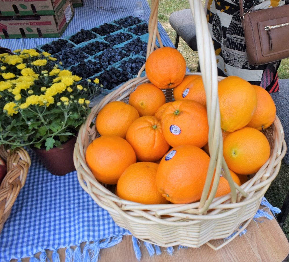 a basket full of oranges sitting on a table