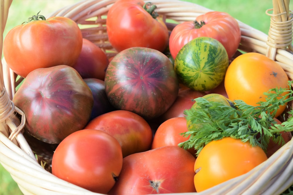 a basket filled with lots of different types of tomatoes