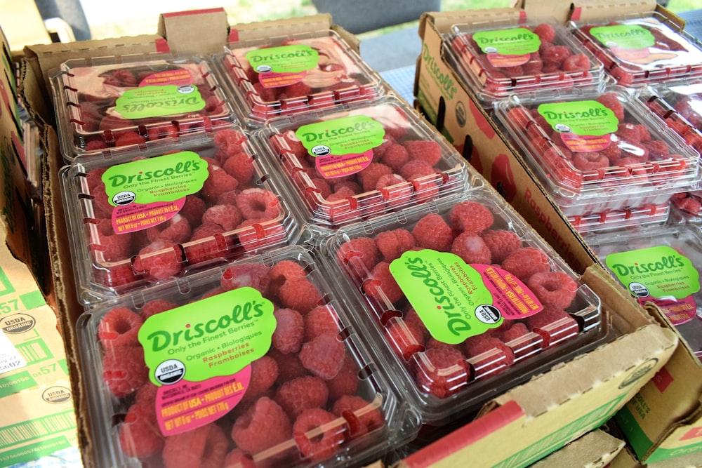 boxes of raspberries are stacked on top of each other