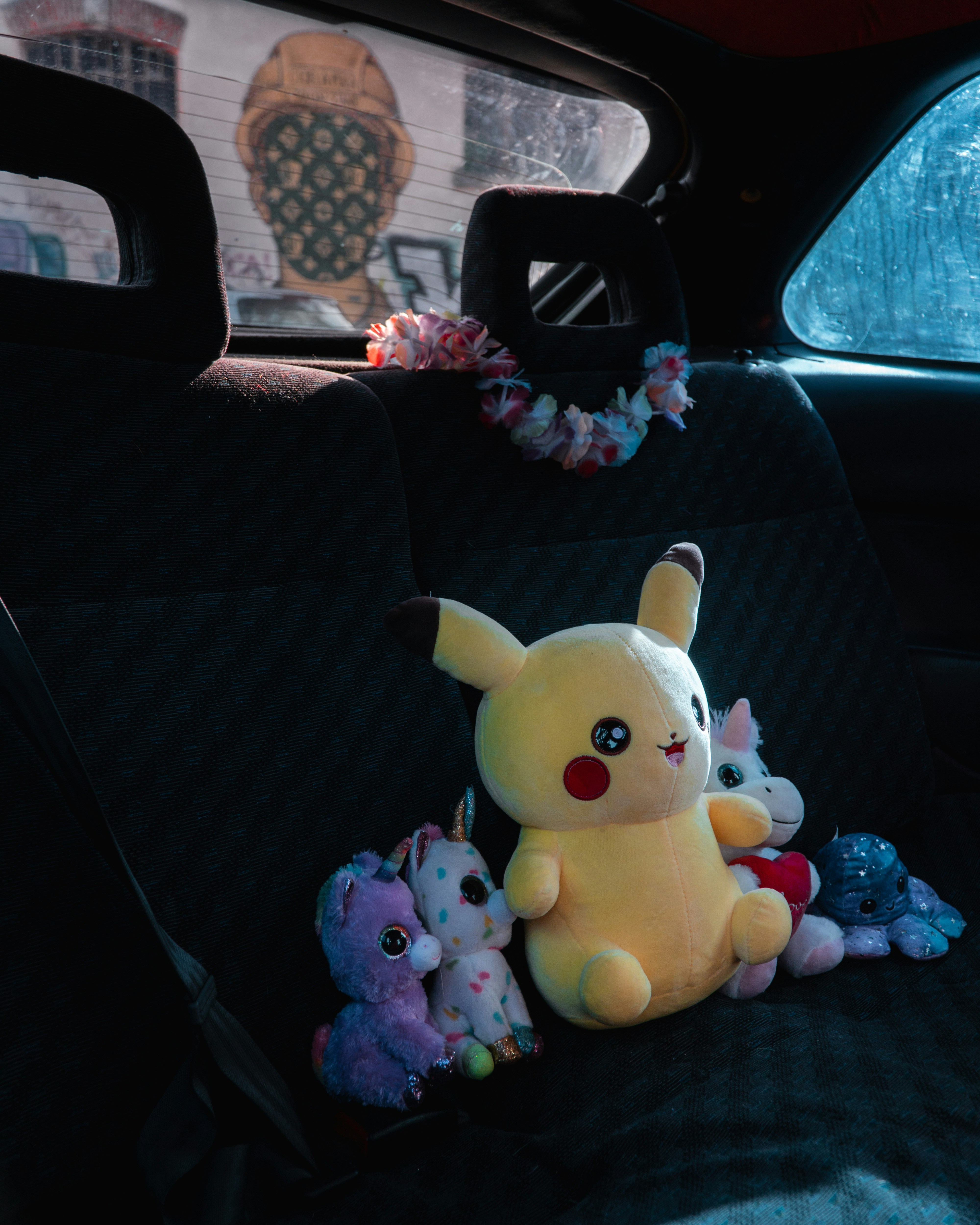 a stuffed animal sitting in the back seat of a car