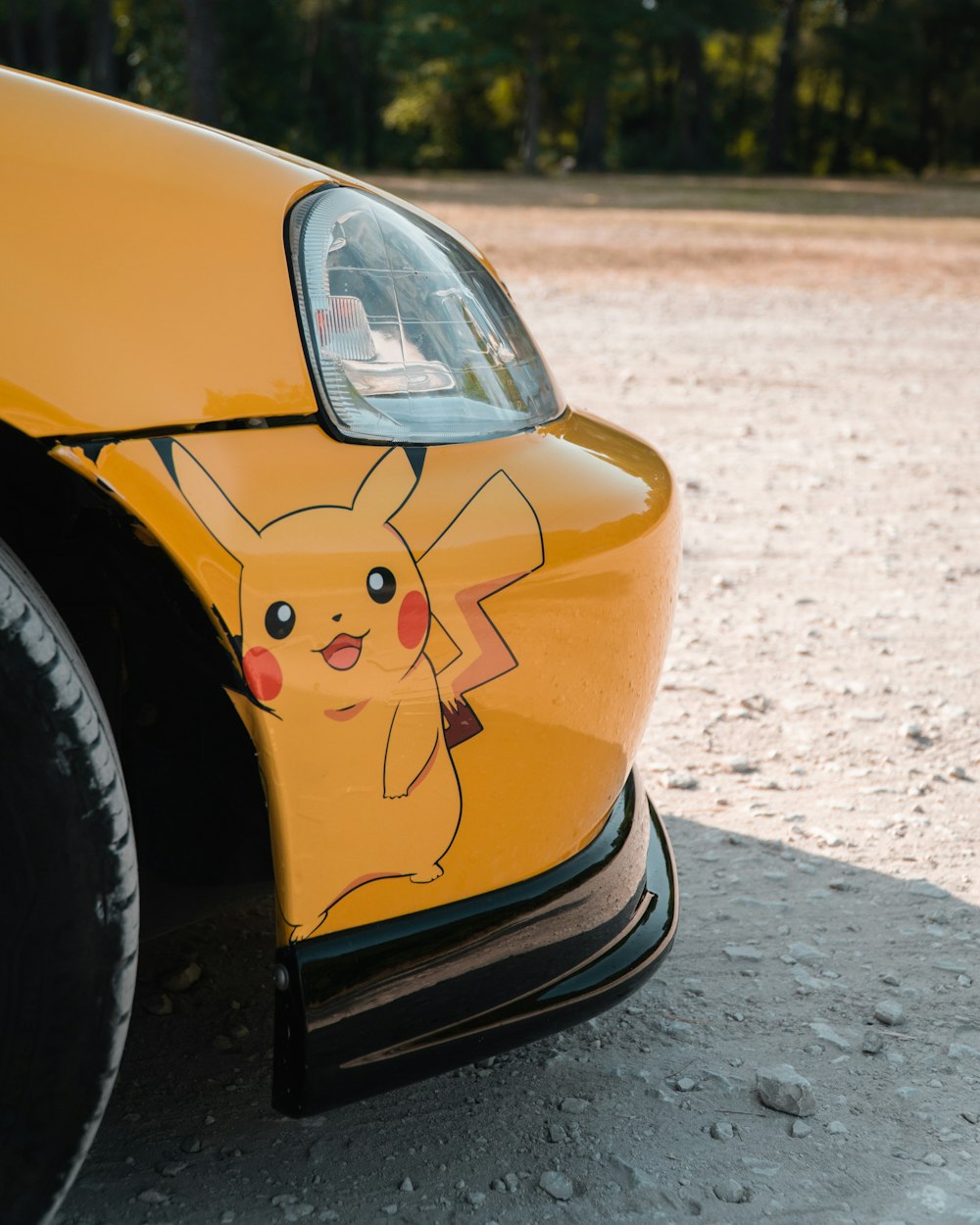 a close up of a car with a pikachu painted on it