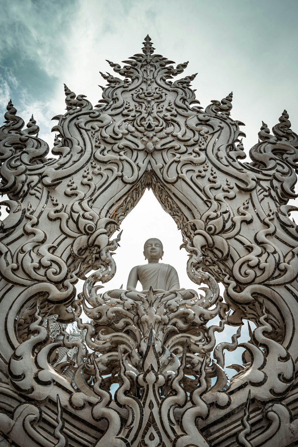 a buddha statue sitting in the middle of a building