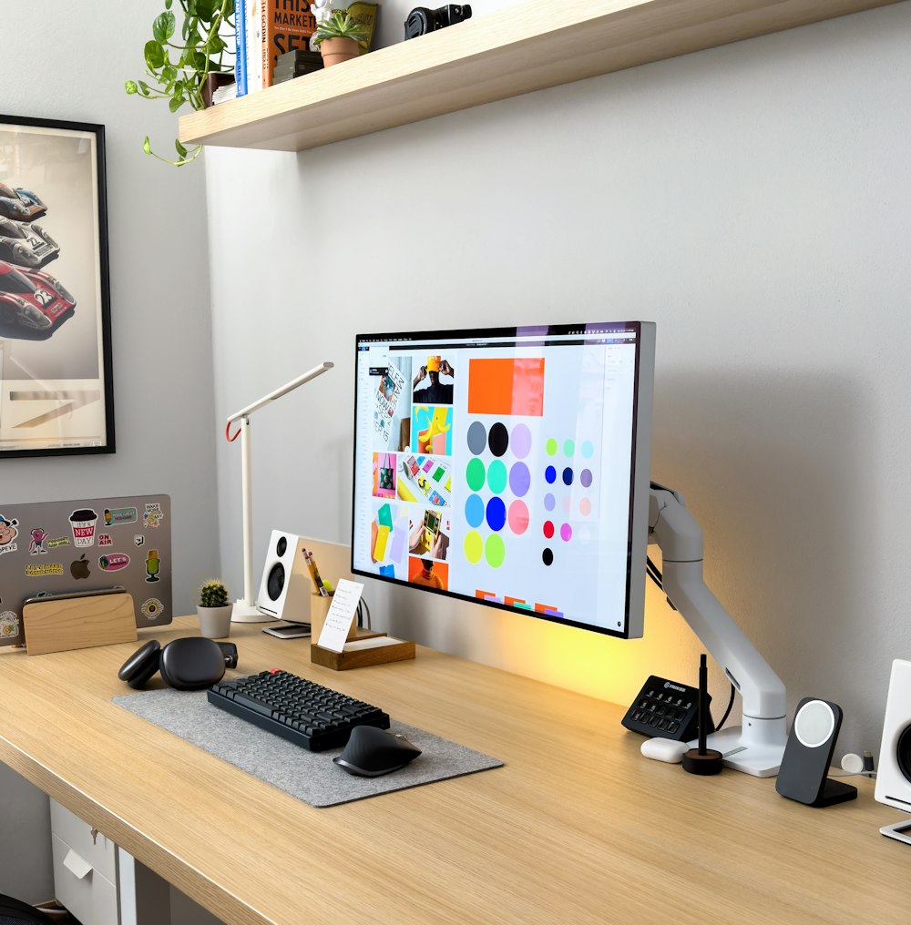 a computer monitor sitting on top of a wooden desk