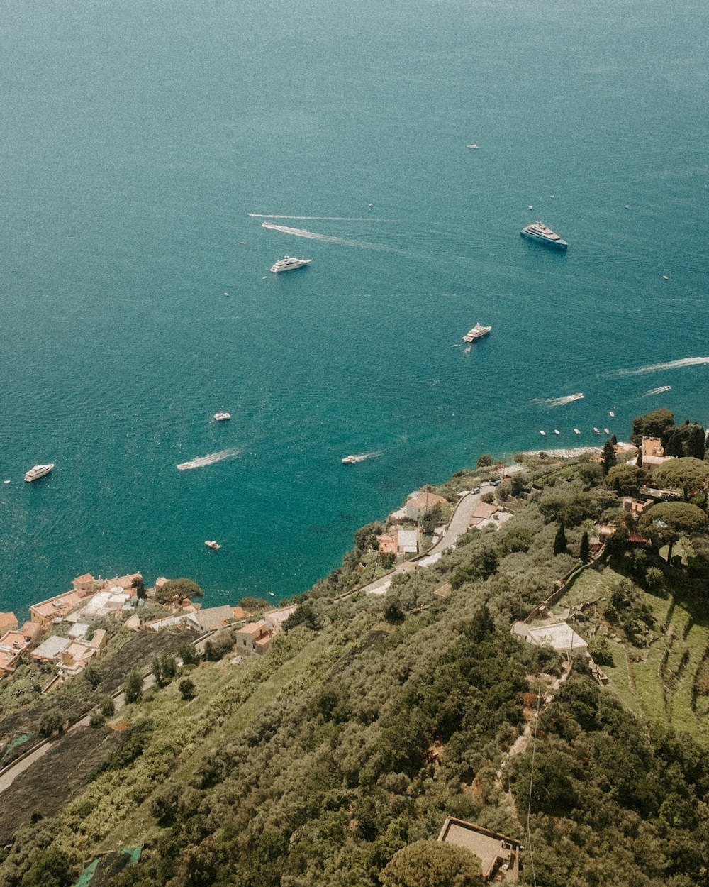 a group of boats floating on top of a large body of water