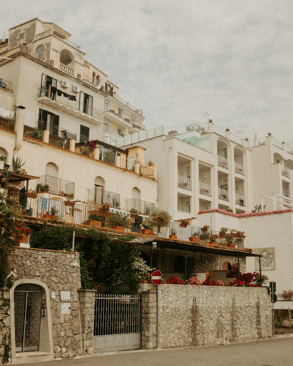 a row of white buildings with balconies and balconies on top of