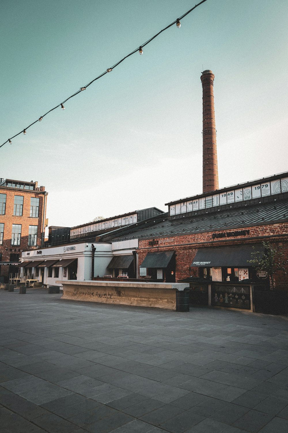 a brick building with a clock tower in the background