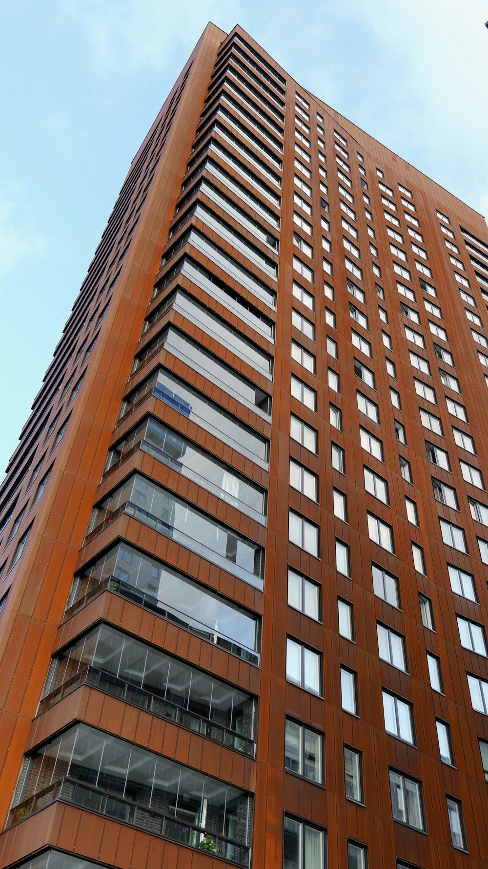 a tall brown building with lots of windows